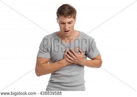 Despaired Sad Young European Handsome Guy Presses His Hands To Sore Spot And Suffers From Pain In Ch