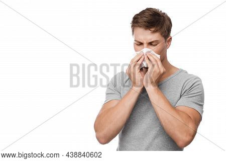 Unhappy Millennial European Attractive Man Blows His Nose In Napkin And Suffers From Runny Nose