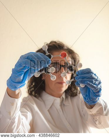 Scientist Studying A Molecular Model Of Diethyl Ether