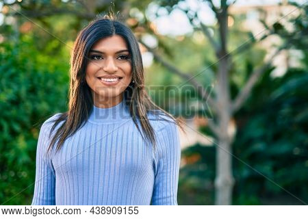 Beautiful hispanic woman smiling confient at the park