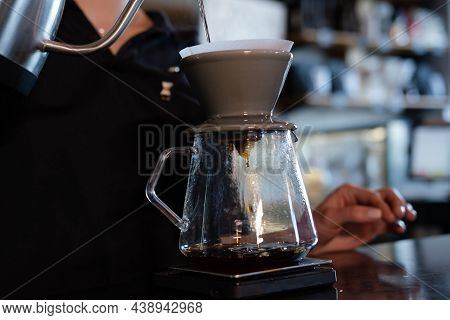 Barista Pour Hot Water On Rough Brown Bubbles Coffee Through Drip Filter, Home Brewing Process. Prep