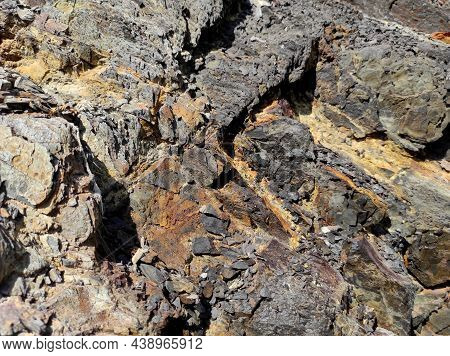 Geodesy. Stone Texture. The Rock Is Brown And Red. Mineral Background. Design From Natural Materials