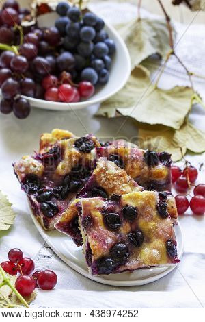 Traditional Italian Yeast Dough Pie With Grapes Schiacciata And Bunches Of Grapes On A Light Backgro