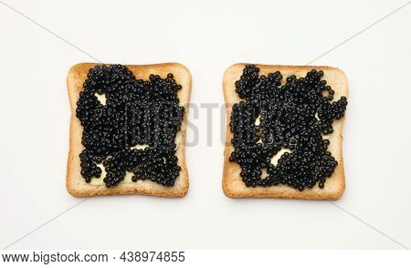 Paddlefish Caviar On A Square Slice Of White Wheat Flour. Top View On White Table