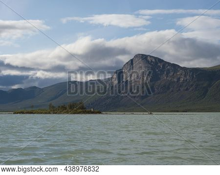 View Over Milky Green Laitaure Lake With Small Island, Hills, Birch And Spruce Tree Forest Lapland L