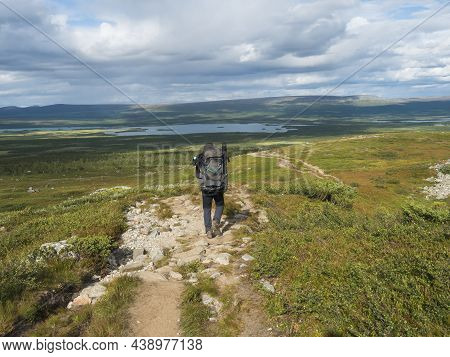 Man Hiker Admiring View On Meandering Glacial Rapadalen River Delta Valley At Sarek National Park, S
