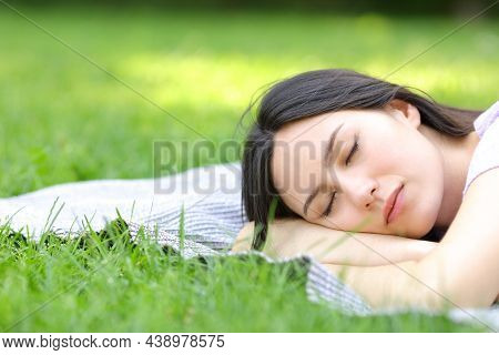 Asian Woman Sleeping Lying On The Grass In A Park