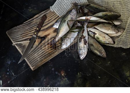 Seafood. Fresh, Unpeeledsea Perches And A Knife Lie Close-up On A Wooden Table