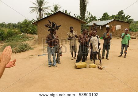Pygmies Dancing And Playing On The Cans.