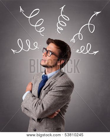 Young man standing and thinking with arrows overhead