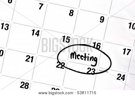 Word Meeting Written And Circled On Calendar