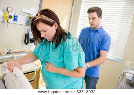 Husband providing acupressure pain relief to BL 32 on the lower back
