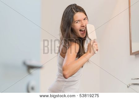 Sexy Playful Woman With A Hairbrush