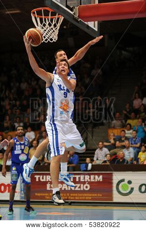 KAPOSVAR, HUNGARY ÃÂ¢Ã?Ã? OCTOBER 26: Soma Kovacs (in white) in action at a Hungarian Championship basketball game with Kaposvar (white) vs. Fehervar (blue) on October 26, 2013 in Kaposvar, Hungary.