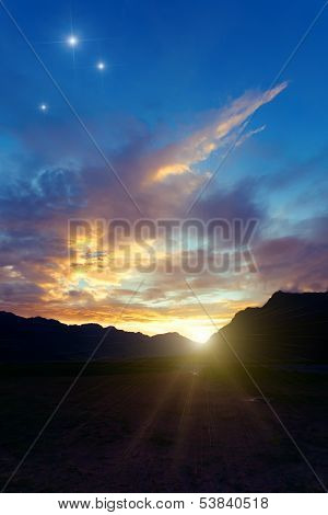 sunrise against clouds and stars.