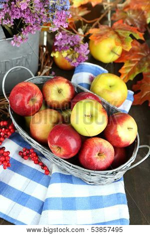 Juicy apples in basket on table close-up