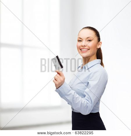 business and bank concept - smiling businesswoman showing credit card