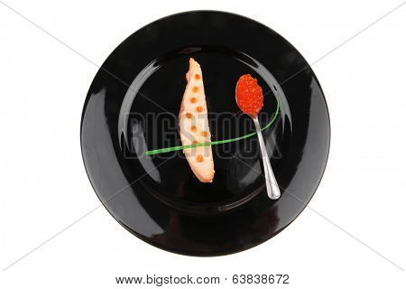 healthy fish cuisine : roasted pink salmon fillet with  onion pen , and red caviar in spoon on black dish isolated over white background