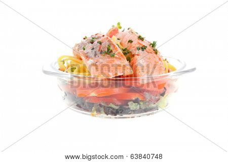 fresh fried natural pink salmon on italian traditional tagliatelle backed with tomato and vegetables isolated over white background