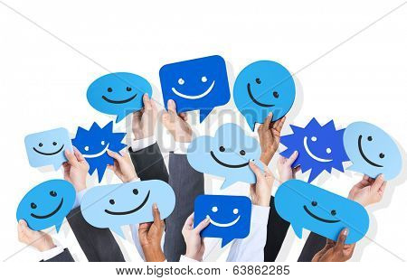 Hands holding smiley faces icons.