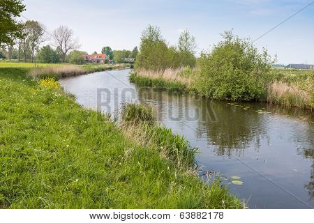 Curved Stream In A Polder Landscape In Springtime