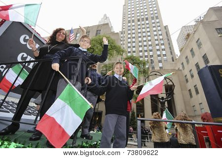 Float riders with Italian flags