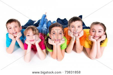 Five beautiful smiling kids lying on the floor in bright colorful t-shirts -  isolated on white.