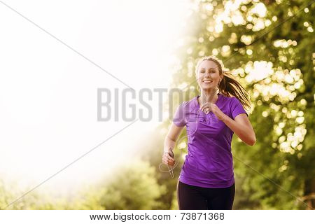 Woman Listening To Music While Jogging