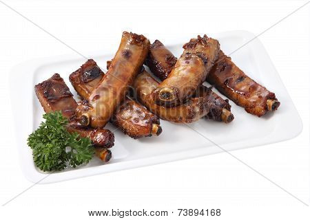 Grilled Pork Ribs On A Plate Isolated On White
