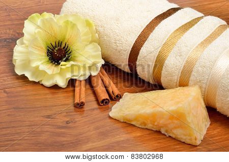 Hndmade Soap, Cinnamon Sticks And Bath Towel On The Wood
