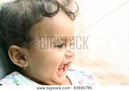Little indian girl laughing and resting on her father