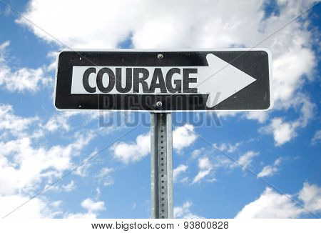 Courage direction sign with sky background