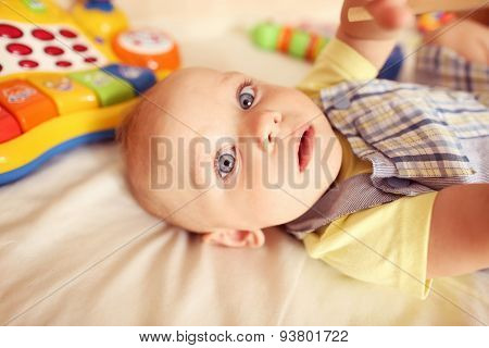Playful Kid In His Bed
