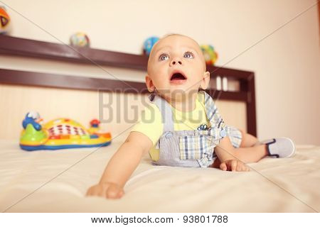 Playful Kid In His Bed