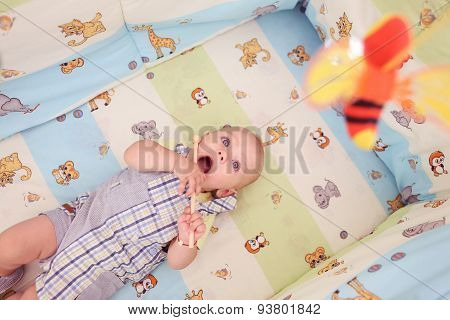 Playful Kid In His Bed