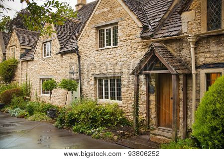 CHIPPENHAM, UK - AUGUST 9, 2014: Castle Combe, unique old English village. Old house and park