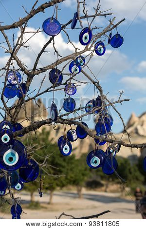 Evil eye in tree behind Uchisar Castle in Cappadocia