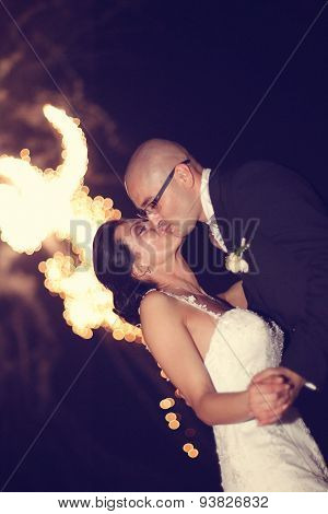 Bride And Groom Surrounded By Fire Crackers