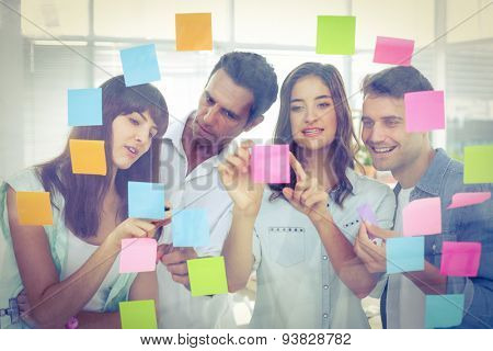 Young creative business people looking at the photo editor at office