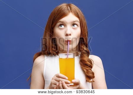Nice girl drinking orange juice