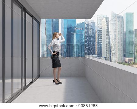 Young Business Lady Is Standing On The Balcony Of The Skyscraper And Looking At The New Business Per