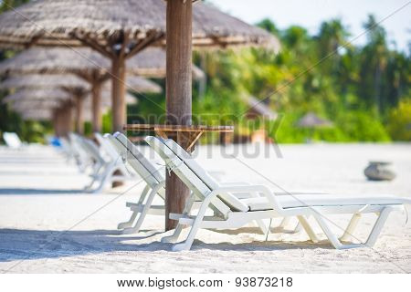 Beach wooden chairs for vacations on tropical beach
