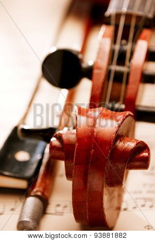 Close Up Of Violin And Bow Resting On Sheet Music