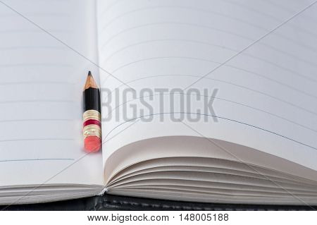 Black Pencil With Pink Eraser On A Paper