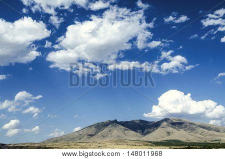 Mount Ara ler in the autumn sunny day against the blue sky covered by clouds