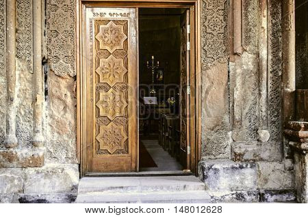 Entrance church wooden door with carved elements folk ornament