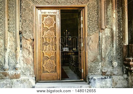 Entrance church wooden door with carved elements folk ornament