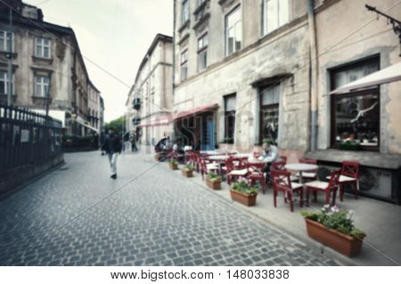 Laid-stone street with cafes shot with blurred focus for background