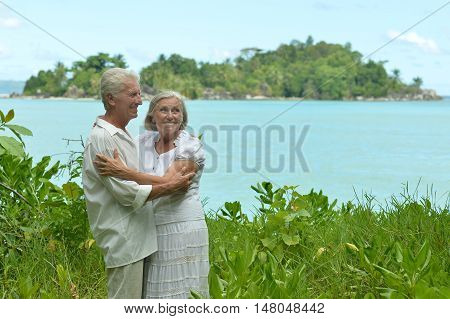 Happy elderly couple rest at tropical beac