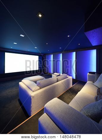 Home theater, luxury interior, comfortable divan and big screen